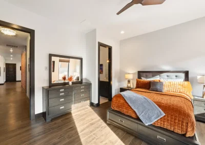 bedroom with a queen bed and dresser with mirror